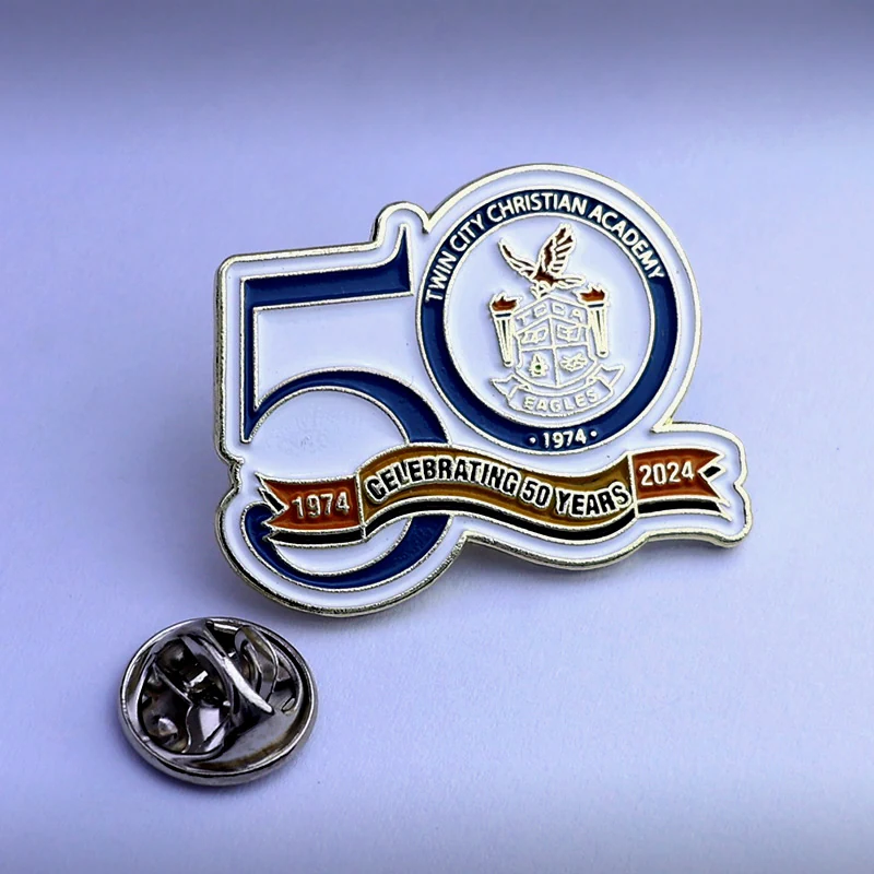 Close-up of the front and back of a custom die struck 50th anniversary lapel pin with safety clasp