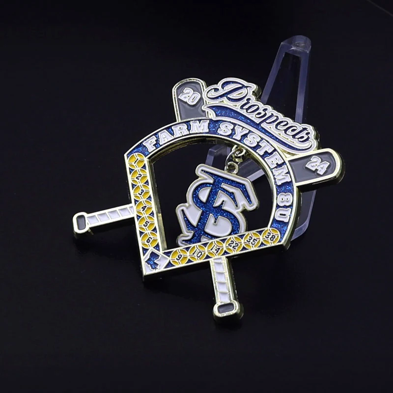 Close-up of a custom baseball lapel pin with team logo and text struck into the metal