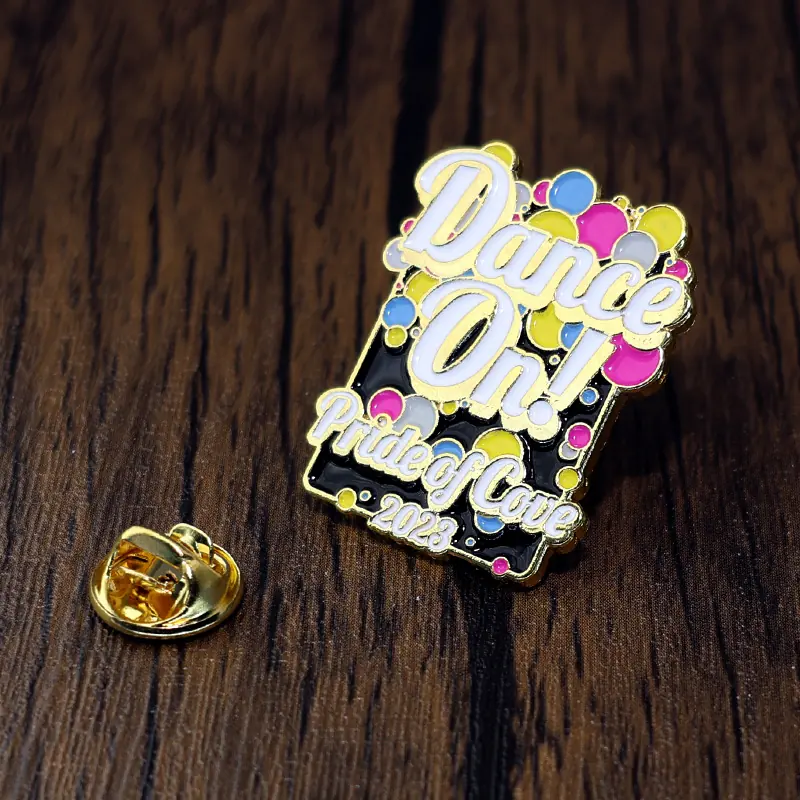 Close-up of the soft enamel fill and gold plating on a custom word lapel pin