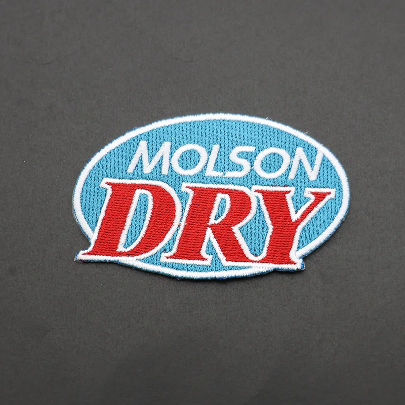 Close-up of the blue DRY backing on the reverse of an embroidered patch, ready for ironing