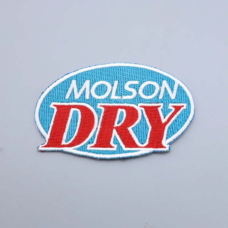 Custom blue DRY embroidered patch with detailed design on a woven base, showing the blue backing side