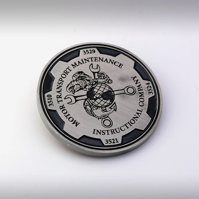 Custom naval challenge coin with antique silver plating and raised relief detailing of a ship insignia
