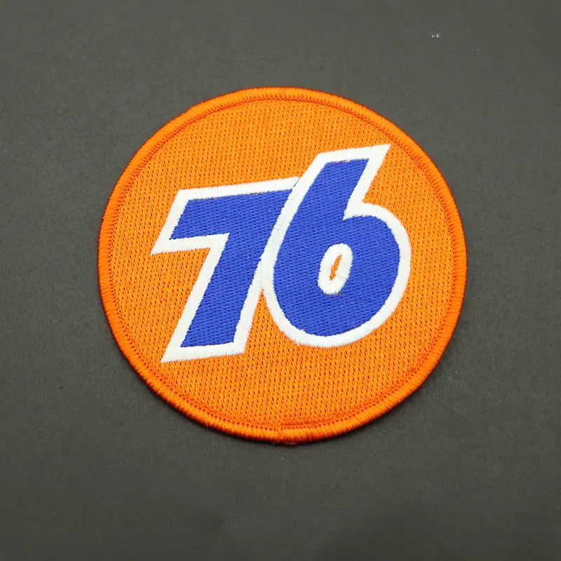 Detail of the reverse side of the embroidered number 76 patch showing heat-pressed backing and attachment options