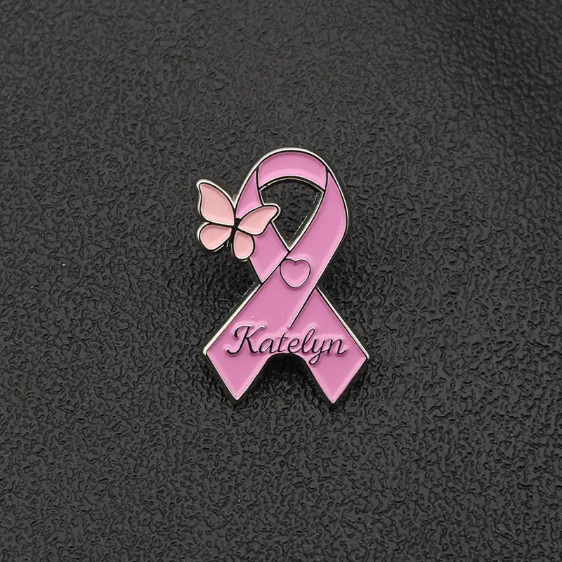Close-up of the back of the pin showing the pin back with rubber stopper and the engraved name detail