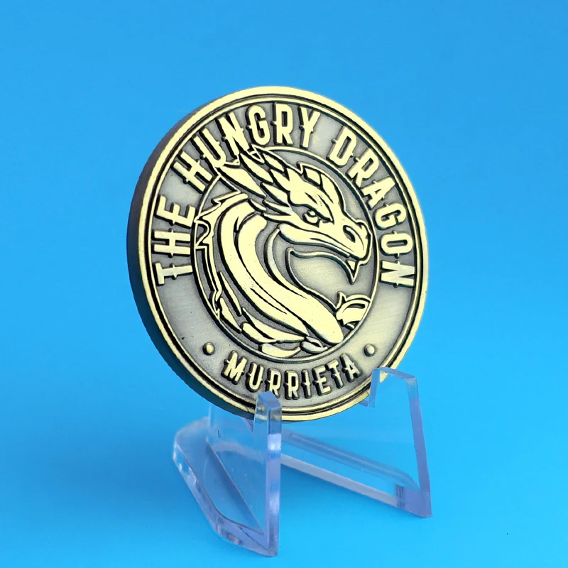 Side view of a custom antique brass dragon head challenge coin showing depth and relief
