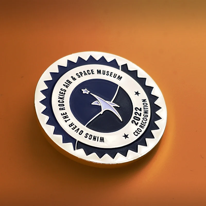 Reverse side and pin back detail of a custom die struck challenge coin with engraved unit name