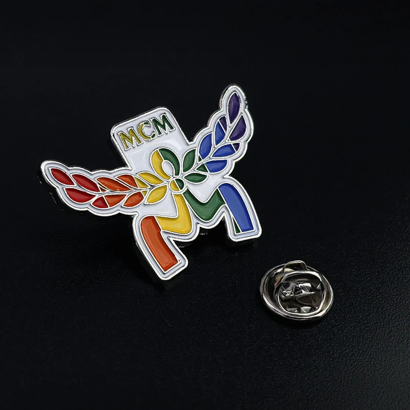Close-up of the olive branch design with textured enamel and metal edges