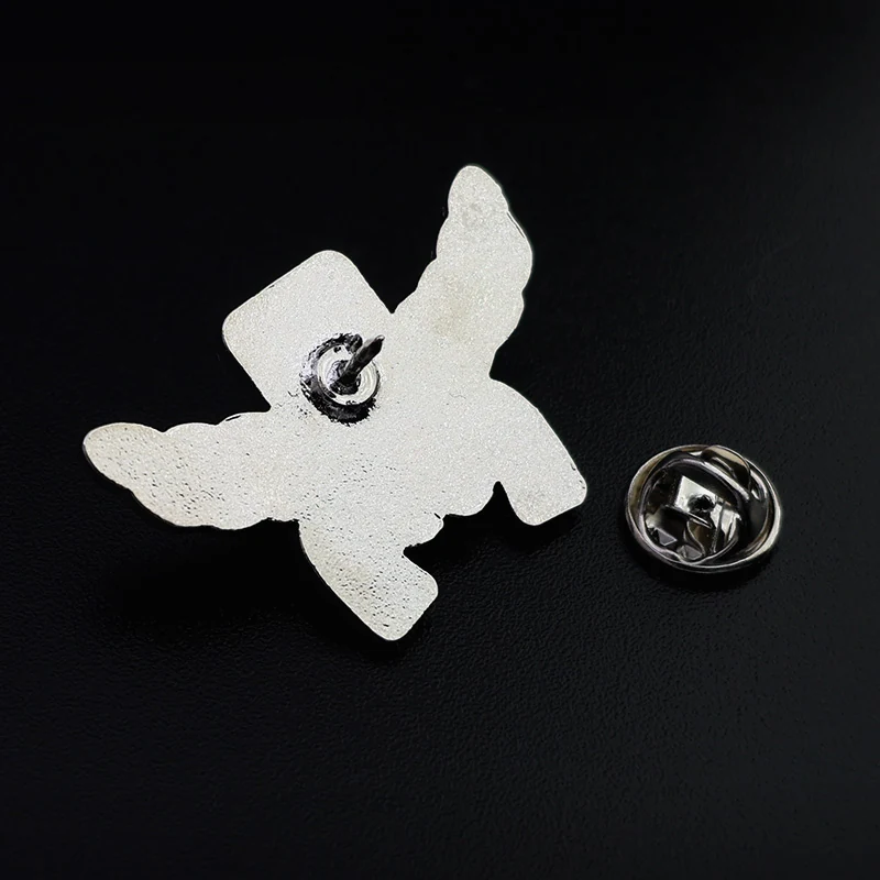 Reverse side of the olive branch lapel pin showing the pin back and base