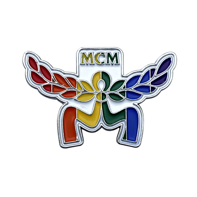Multiple olive branch pins arranged on a white background with varied plating