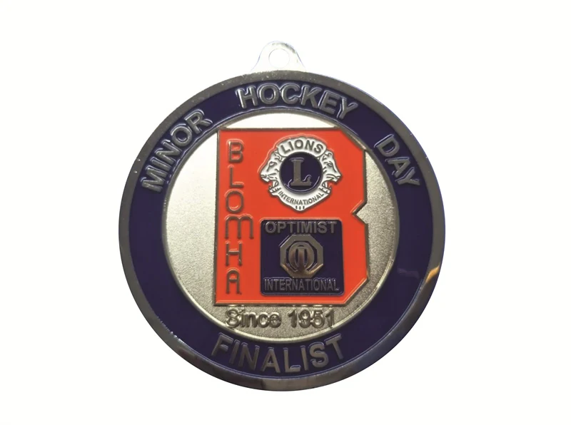 Custom gold hockey medal with red white and blue enamel on a printed neck ribbon