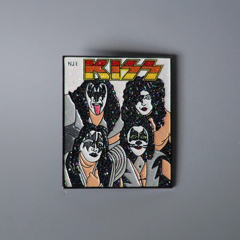 Close-up of the KISS logo and glitter accents on the front of the enamel pin with a clear epoxy dome