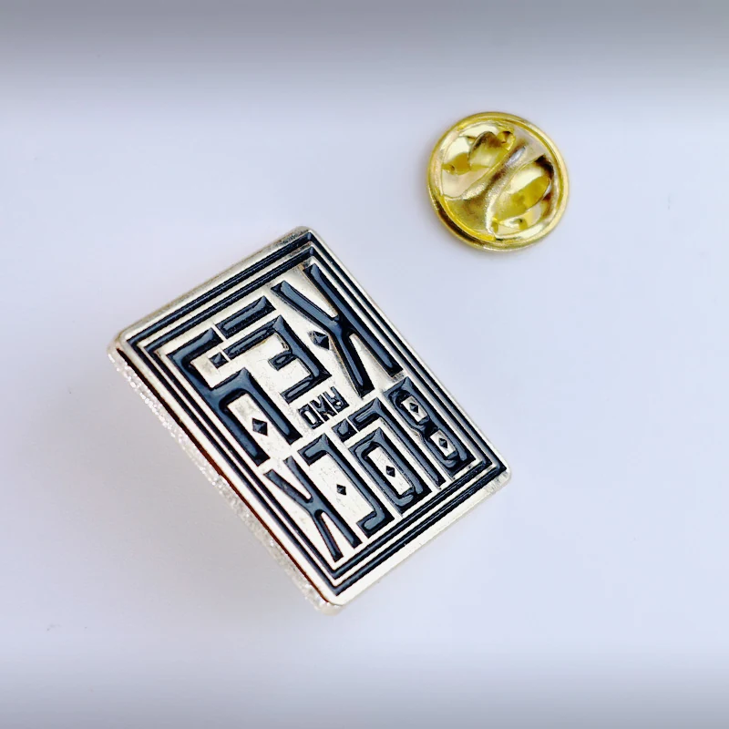 Close-up of the key block attachment and rubber clutch on a custom enamel lapel pin