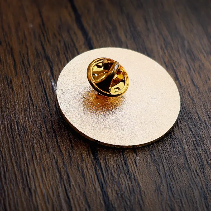 Side view of a custom round star lapel pin showing the raised die struck edges and enamel fill