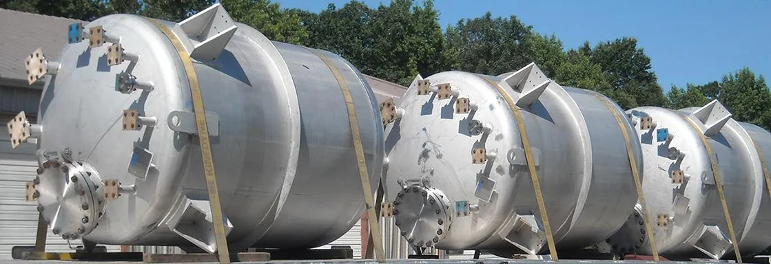 Row of stainless steel pressure vessels standing outside the works before shipment