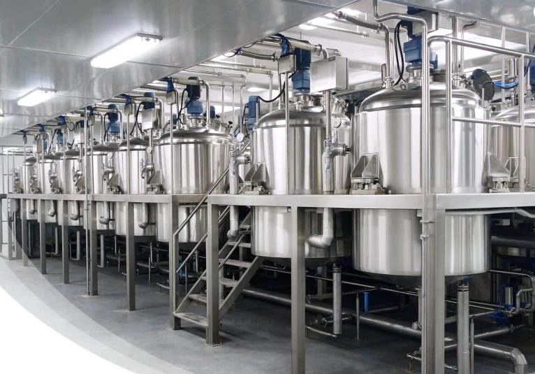 Stainless steel process tanks with agitators installed on a plant floor