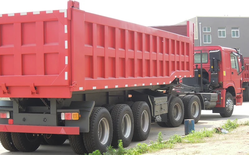 SINOHENG rear flip tipper semi-trailer with body raised for discharge view 2