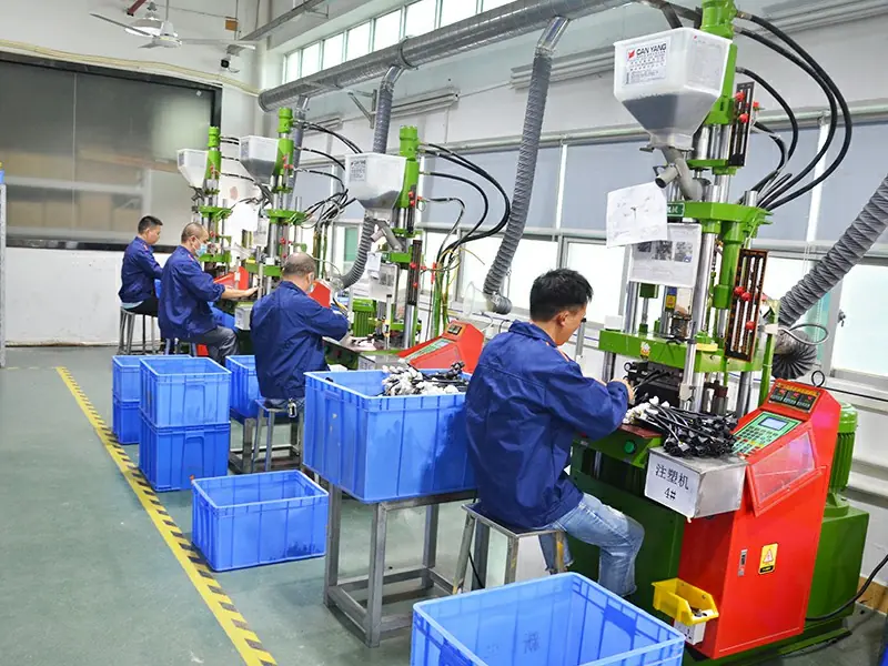Operators assembling OBD cable harnesses on the Setolink production line