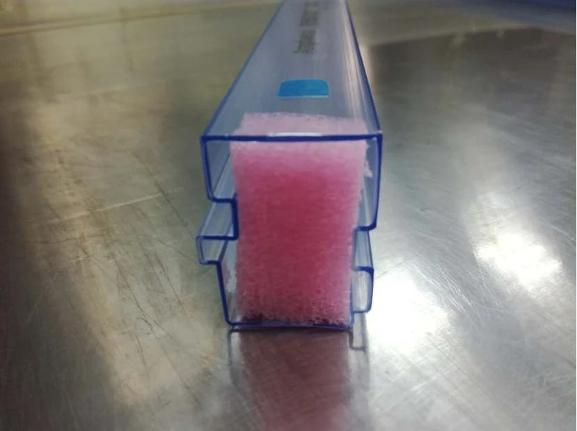 Blue and transparent connector tubes stacked in bundles ready for packing