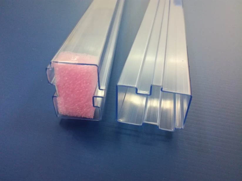 Two clear plastic extruded channel profiles, one holding a pink foam strip