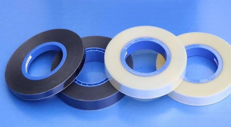 Transparent and light brown cover tape rolls on spools ready for packaging