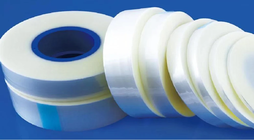 Close-up of a cover tape surface showing the adhesive layer and liner