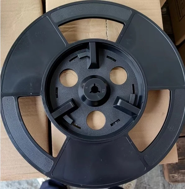 Plastic reels in various sizes displayed with a ruler for scale
