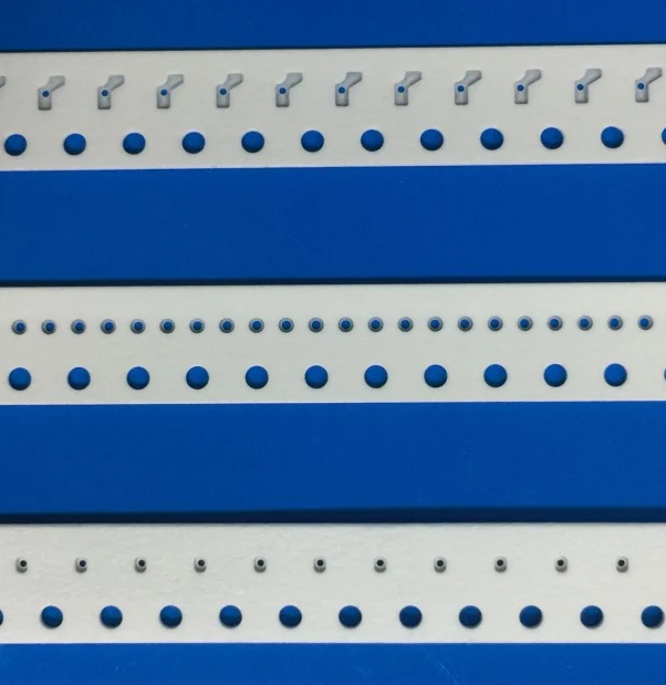 Pre-punched paper carrier tape with round center cavity showing the central hole and pocket structure