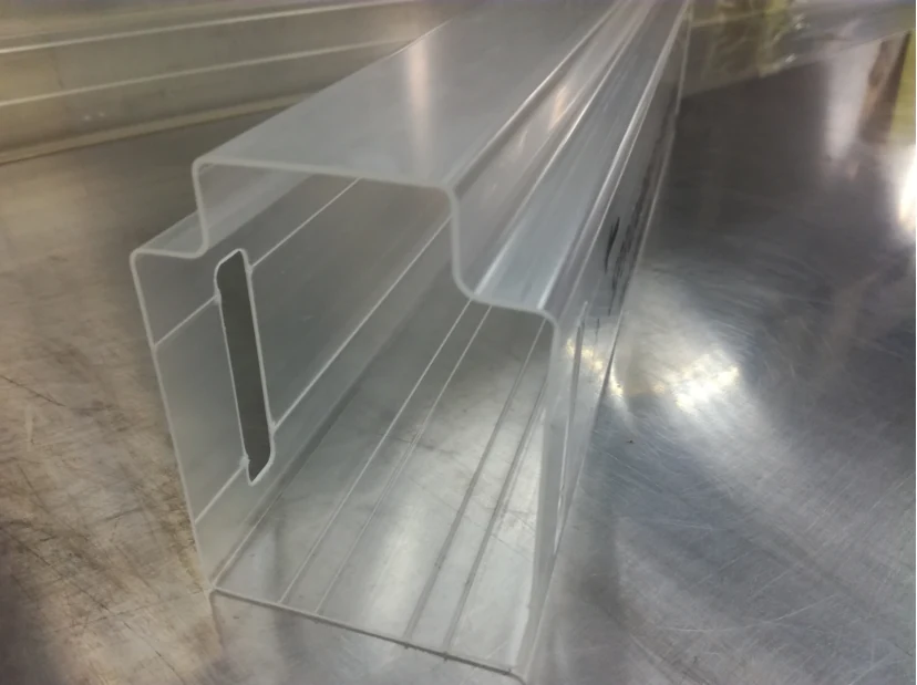 Translucent extruded plastic profile with slotted opening lying diagonally
