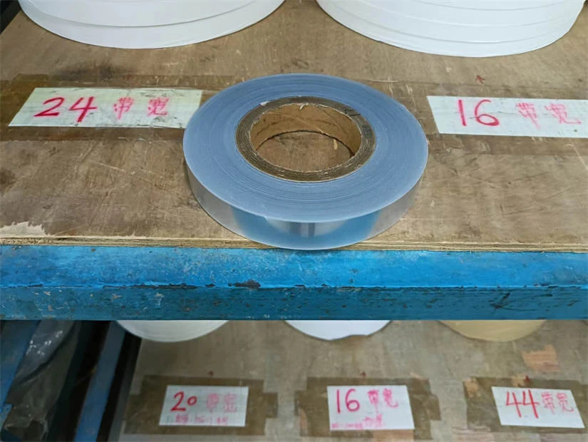 Two-color PSA cover tape rolls side by side for visual comparison
