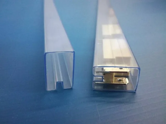Two clear plastic extrusion profiles standing upright