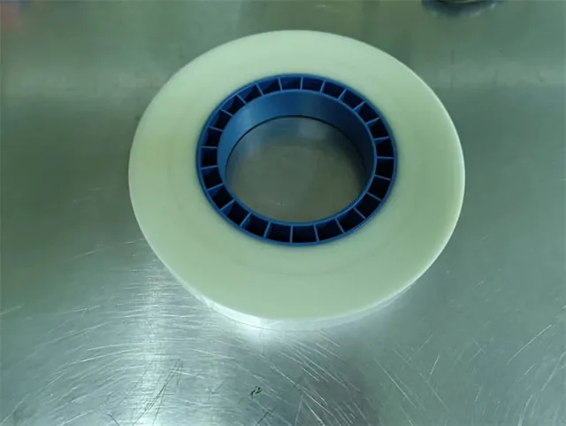 PSA cover tape being applied to a carrier tape in a production line