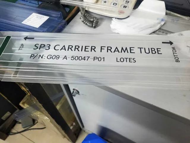 A clear plastic carrier frame tube labeled with part number G09 A-50047-P01