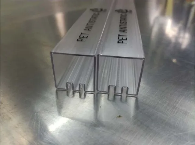 Two clear PET antistatic rectangular plastic tubes standing upright
