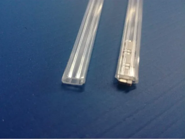 Two clear quartz tubes on a blue surface, one