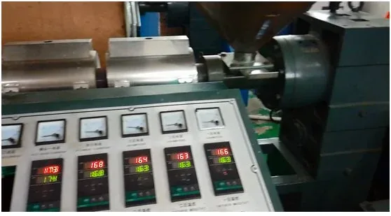 Close-up of an industrial machine control panel with analog gauges