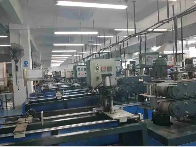Interior of a factory showing a long production line with blue