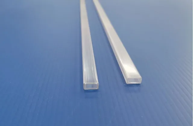 Two translucent clear plastic rectangular strips lying