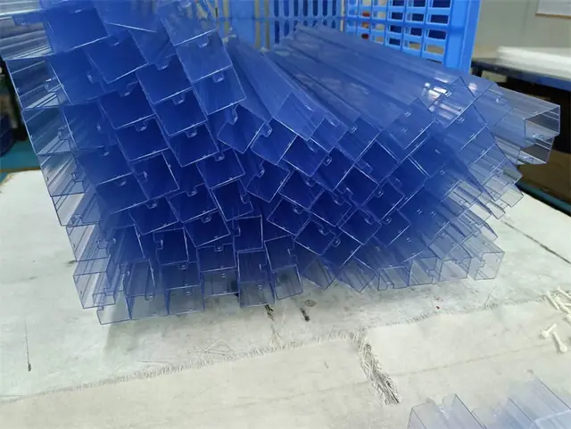 Bundle of translucent blue U-channel plastic profiles stacked