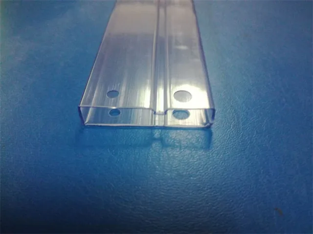 Transparent plastic extrusion profile with drilled holes