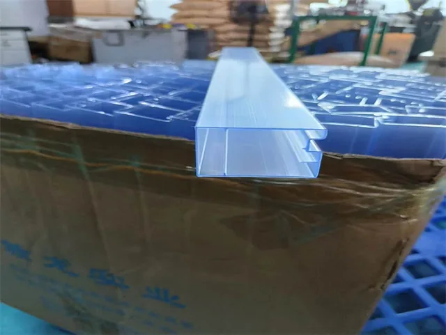 Clear and translucent plastic profiles stacked on cardboard boxes