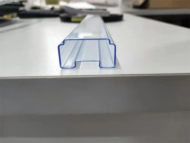 Translucent blue plastic U-channel profile extrusion photographed