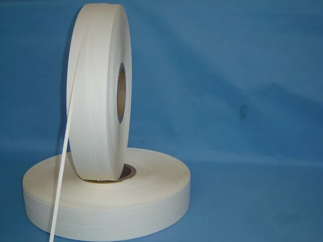 Un-punched paper carrier tape roll with adhesive side visible, ready for punching and printing