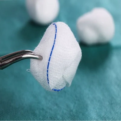 Absorbent cotton gauze balls in round and peanut shapes