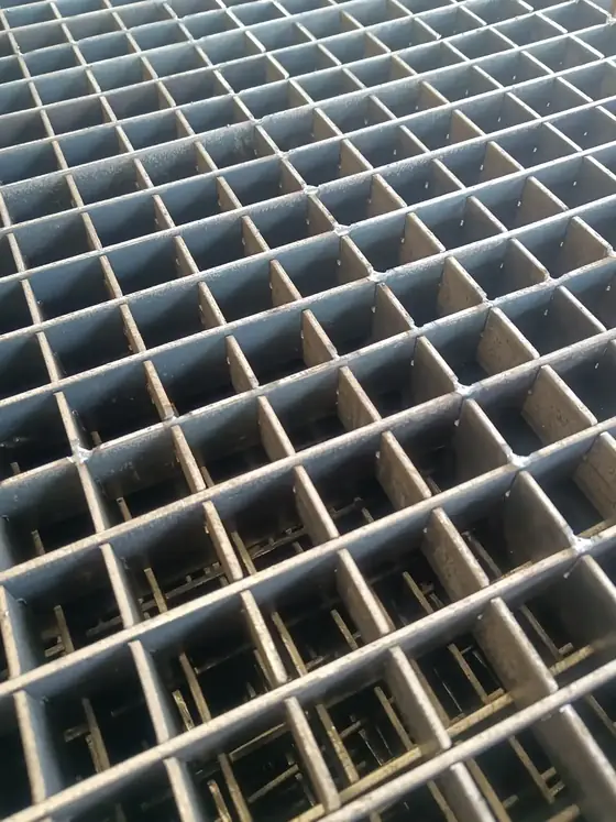 Close view of press locked steel grating showing the flush joint between bearing bar and cross bar