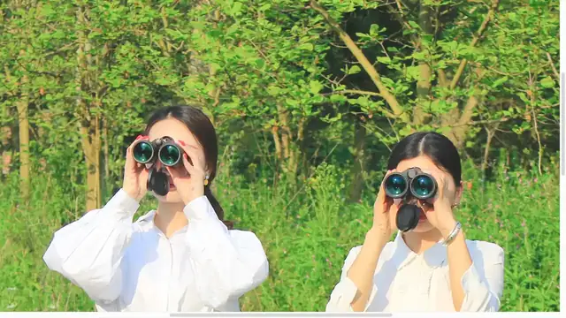 Shinyzen staff with binoculars in the field