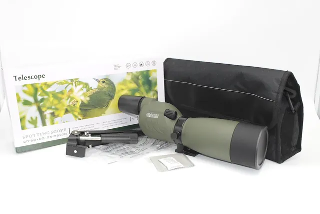 Green spotting scope with black carrying case, tripod mount, and packaging box on a white background