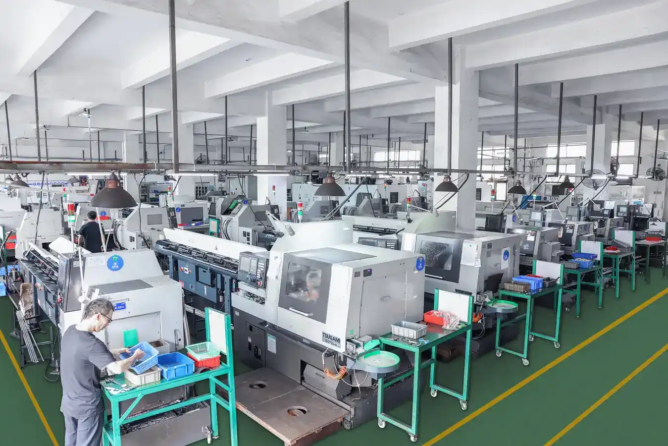 Row of Japanese sliding-head lathes running in the Shipu Precision workshop in Shenzhen