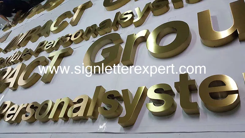 Golden brushed stainless steel letter signage