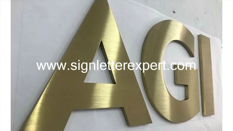 Golden brushed stainless steel letter signage