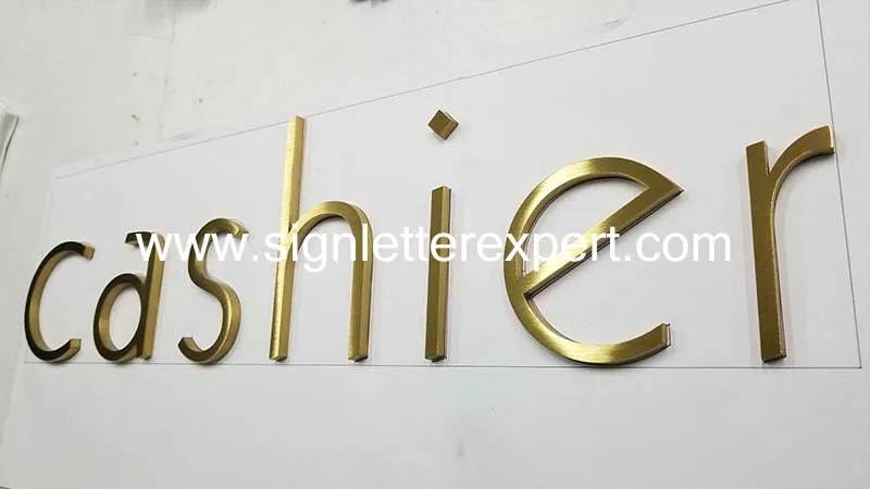 Golden brushed stainless steel letter signage